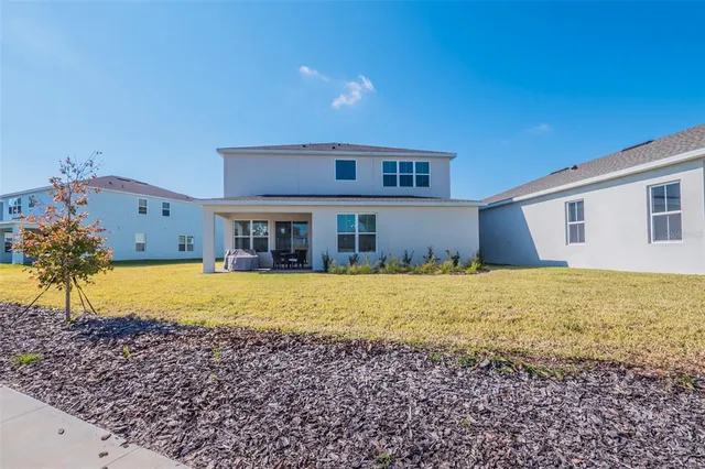 a living room with furniture and a dining table