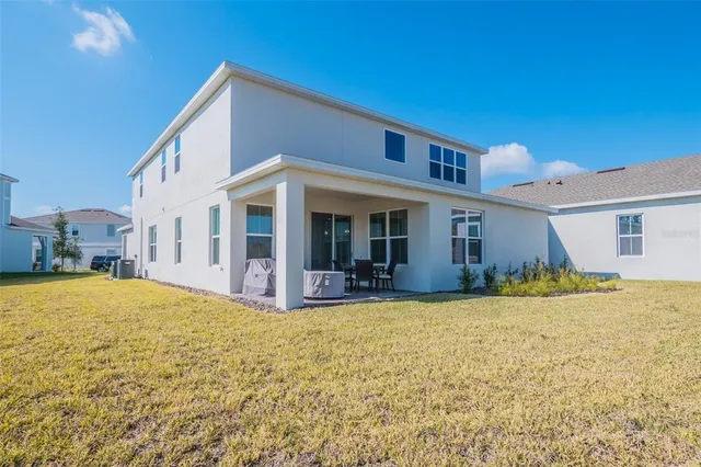 a kitchen with stainless steel appliances granite countertop a sink a stove a refrigerator and island with wooden floor