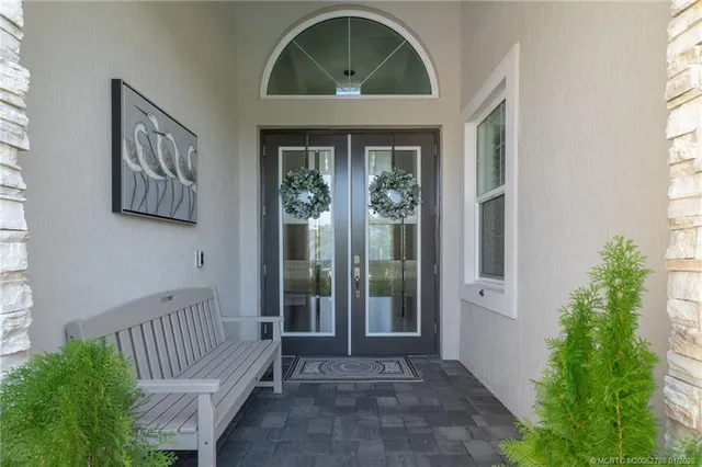 a living room with furniture a flat screen tv and a large window