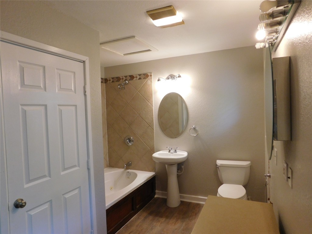 Undisclosed Address Austin, TX 78754 - Photo 15 of 18 a bathroom with a toilet a sink and mirror
