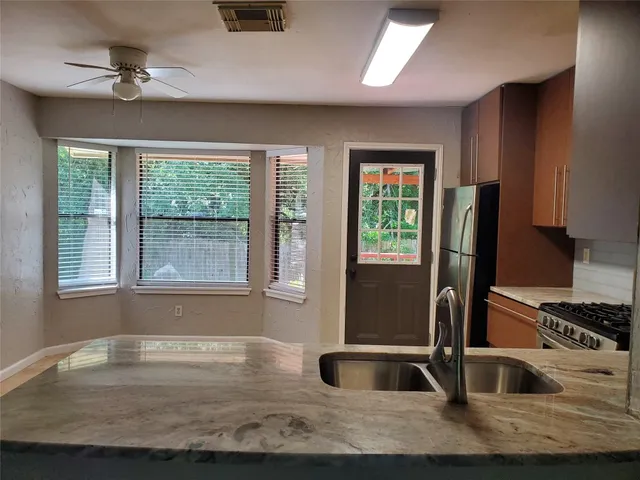 a kitchen with granite countertop a sink and a window