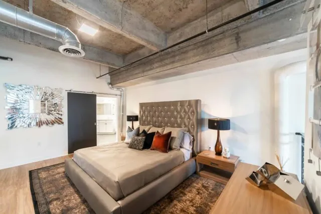 a bed room with a bed and a chair