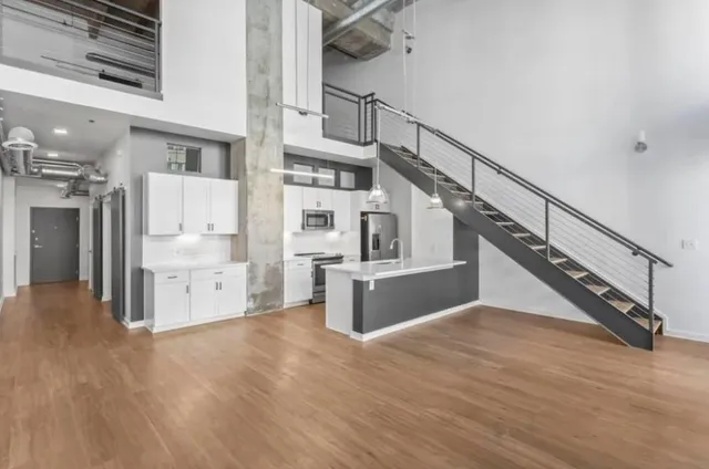 a view of kitchen and hallway with wooden floor