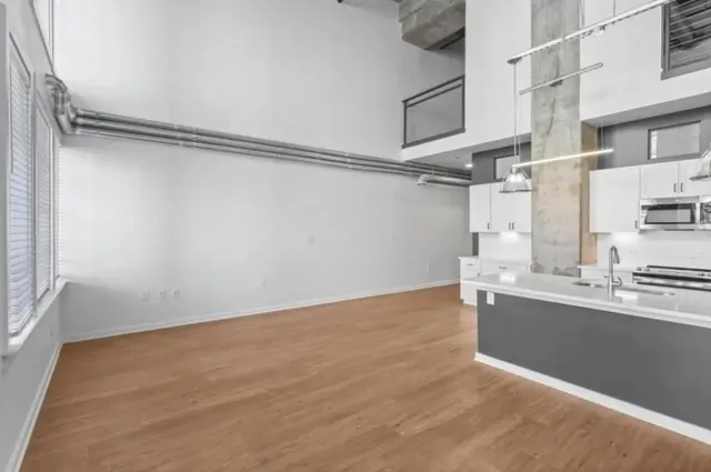 a view of a room with wooden floor and cabinets