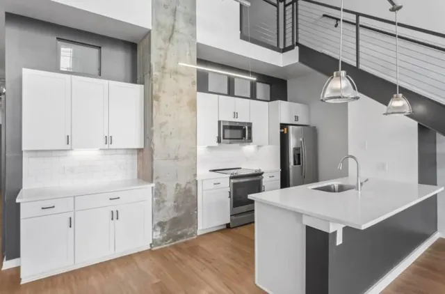 a kitchen with a sink stainless steel appliances and cabinets