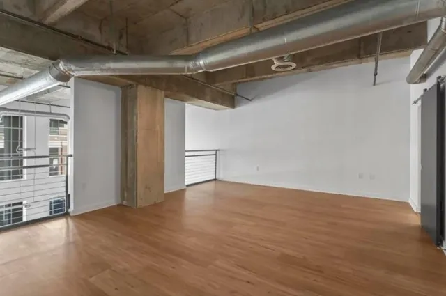 a view of a room with wooden floor