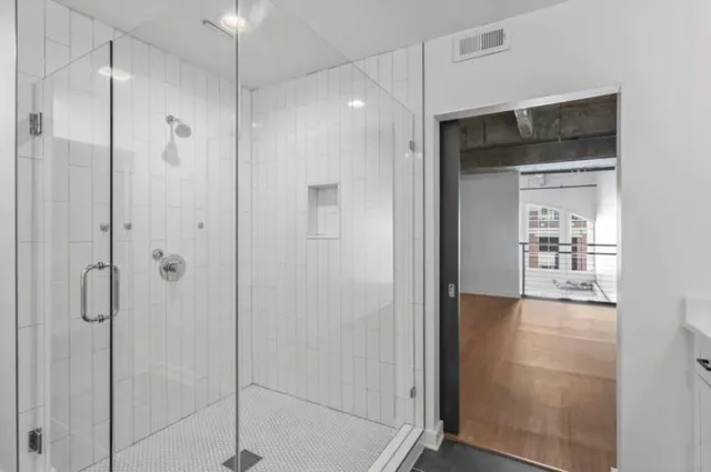 a bathroom with a shower and a glass door