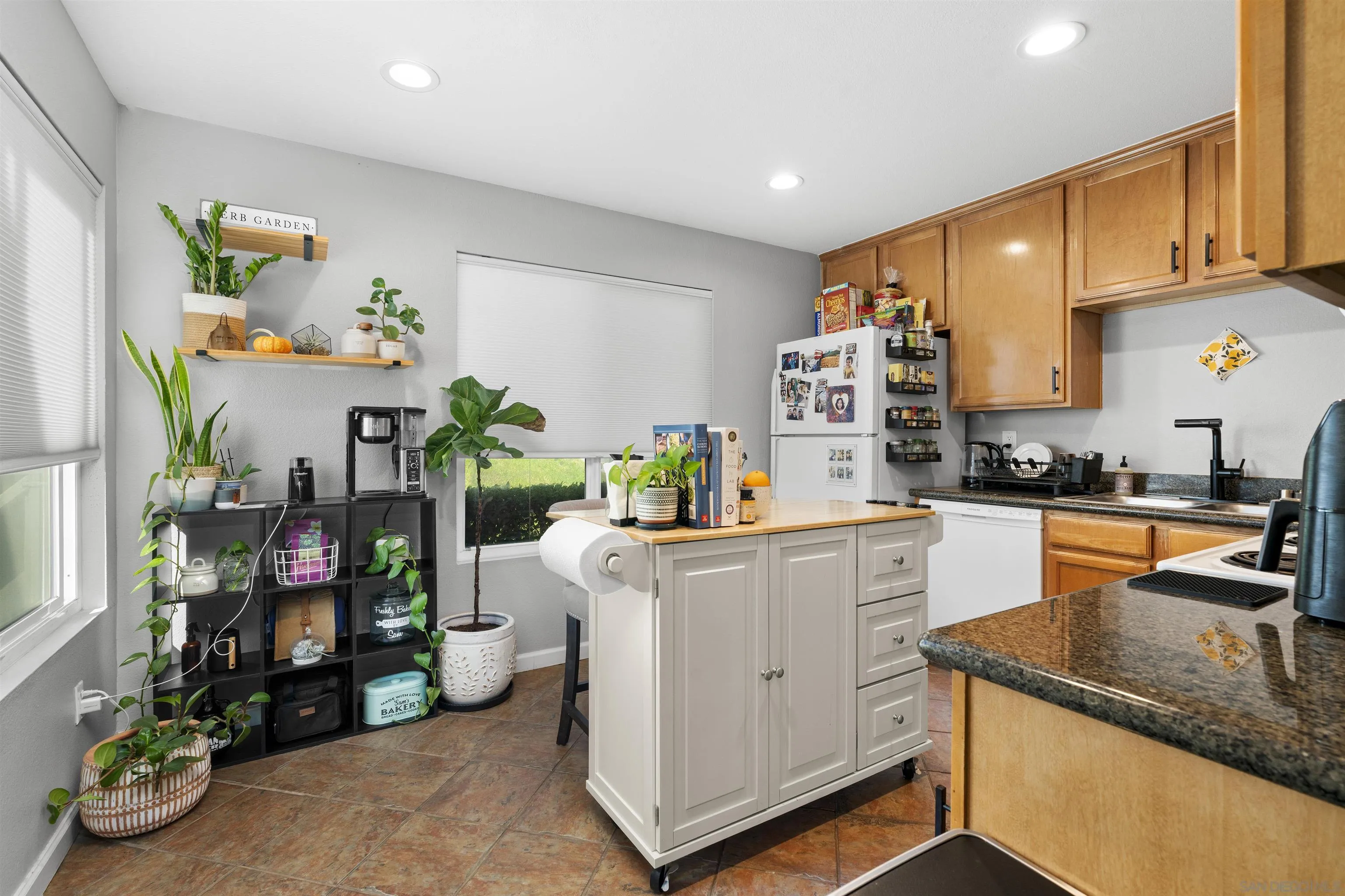 a kitchen with white cabinets and appliances