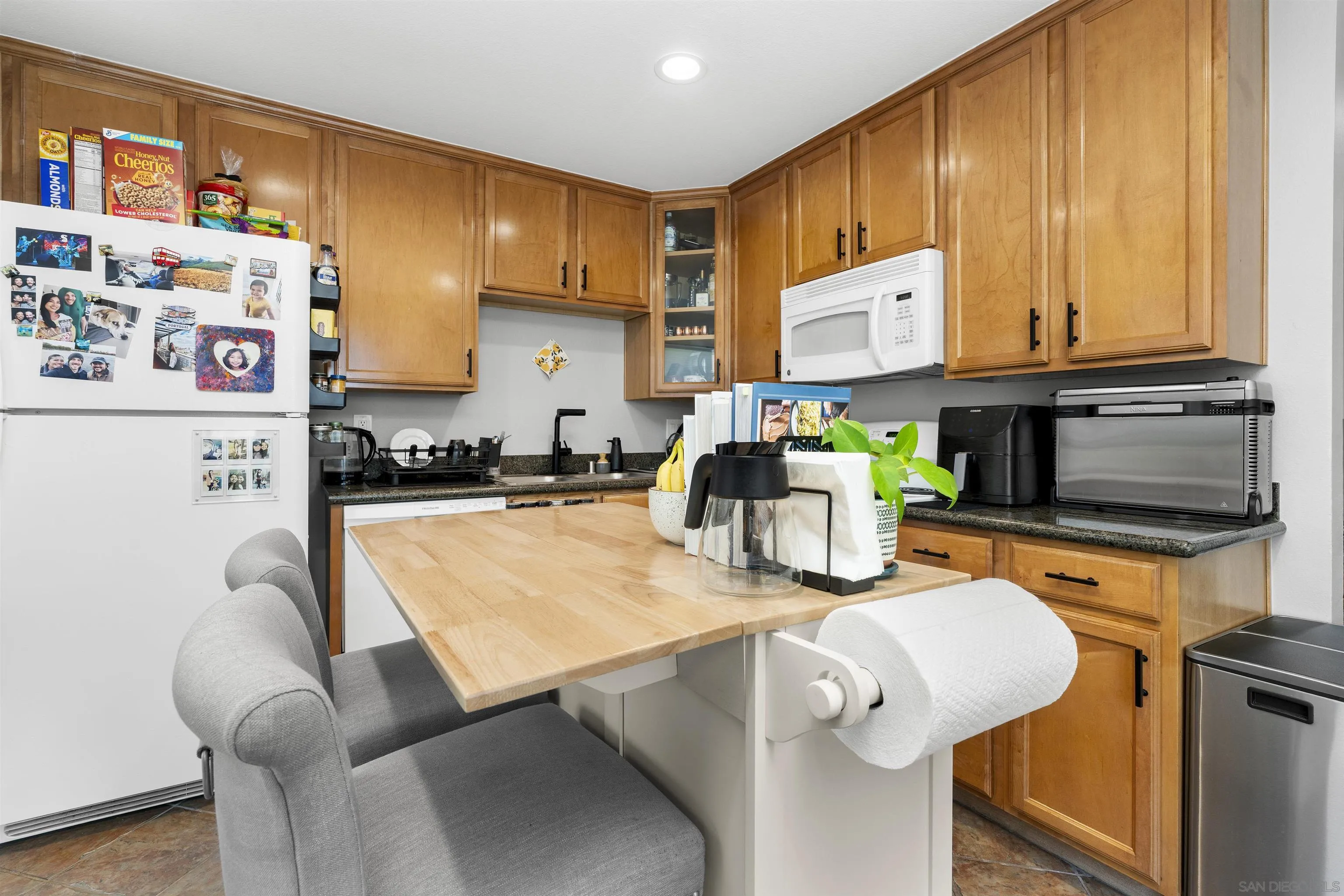 6333 College Grove Way, Unit 1101 (14) San Diego, CA 92115 - Photo 13 of 39 a kitchen with stainless steel appliances granite countertop a sink refrigerator and cabinets