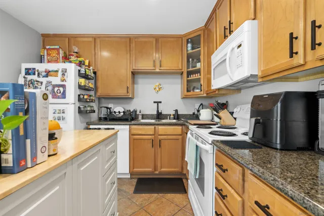 a kitchen with stainless steel appliances granite countertop a sink and cabinets
