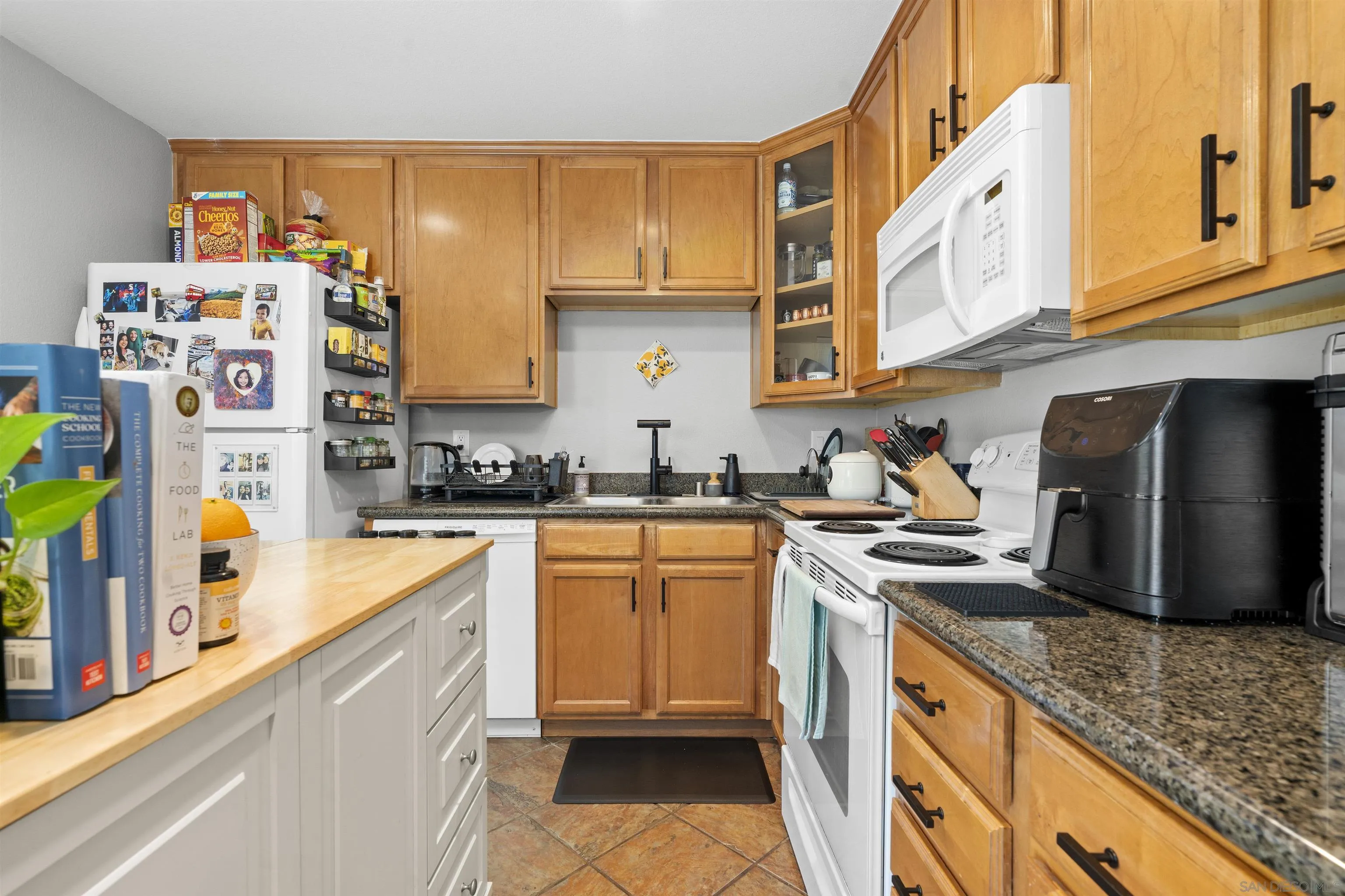 6333 College Grove Way, Unit 1101 (14) San Diego, CA 92115 - Photo 16 of 39 a kitchen with stainless steel appliances granite countertop a sink a stove and refrigerator