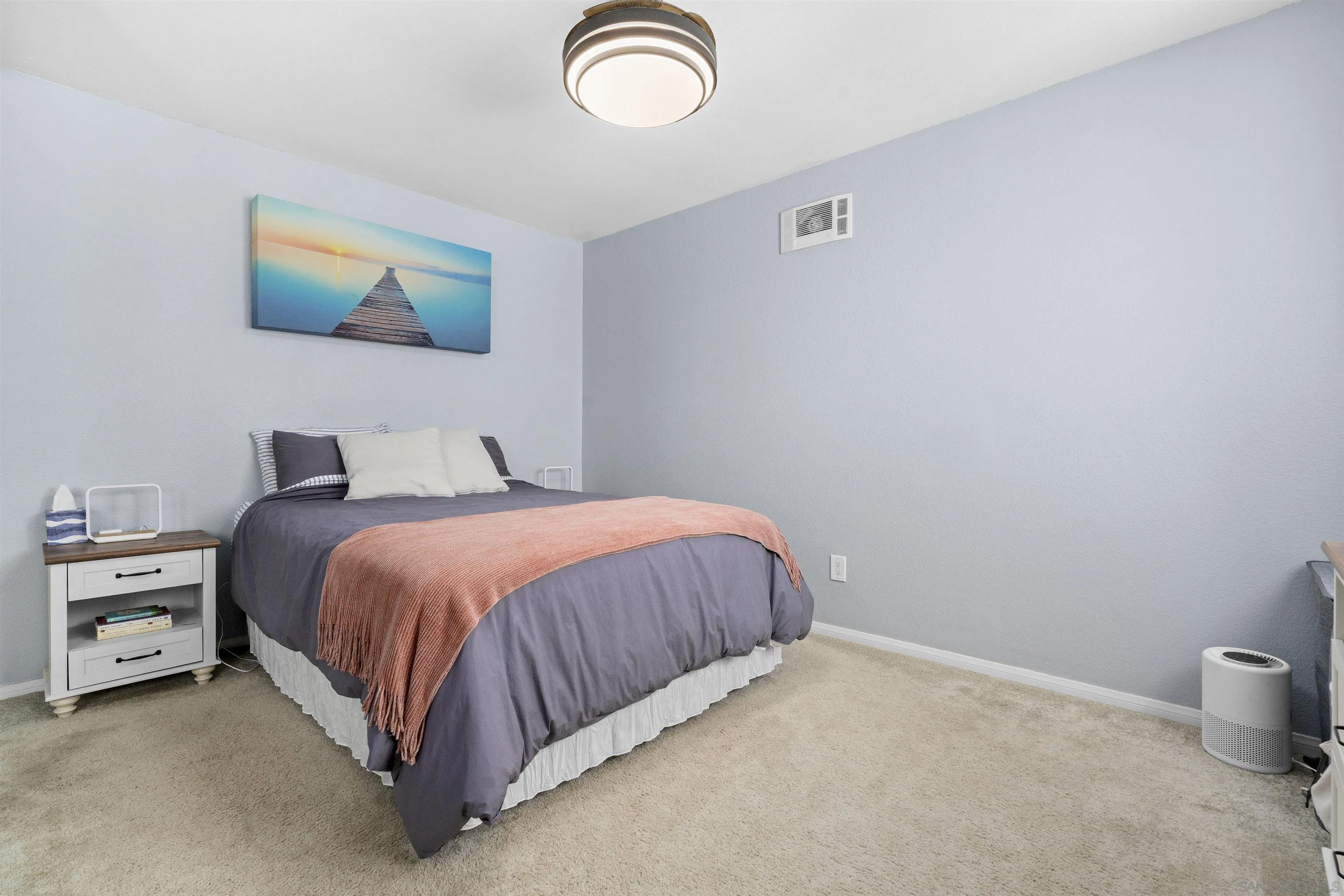 6333 College Grove Way, Unit 1101 (14) San Diego, CA 92115 - Photo 23 of 39 a spacious bedroom with a bed and a painting on the wall