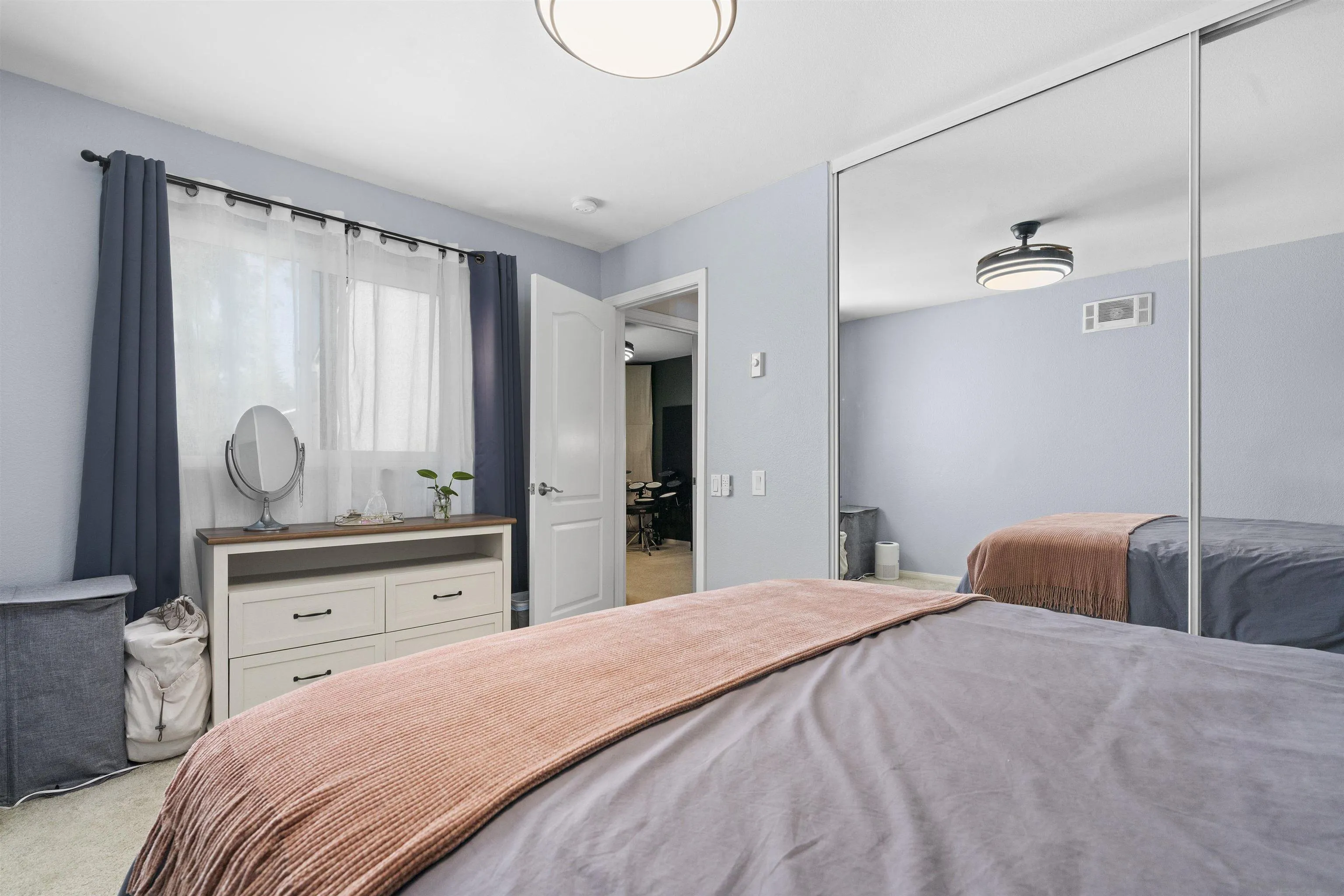 6333 College Grove Way, Unit 1101 (14) San Diego, CA 92115 - Photo 24 of 39 a bedroom with a large bed and chandelier