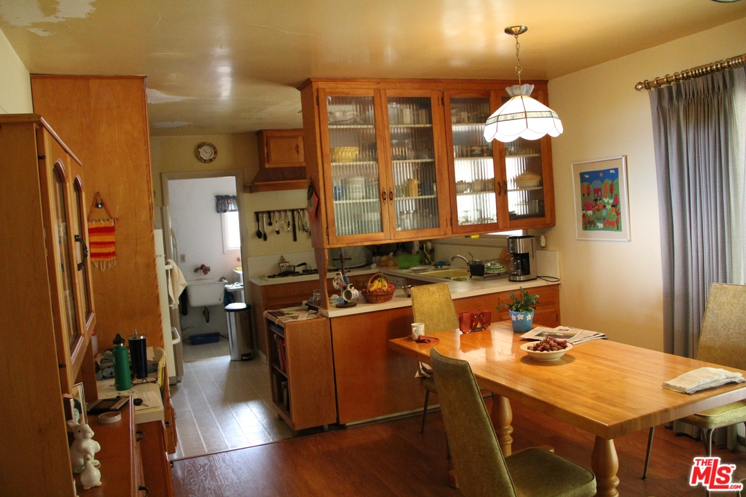 20490 Seaboard Road Malibu, CA 90265 - Photo 22 of 43 a room with a chandelier furniture a chandelier and a view of kitchen