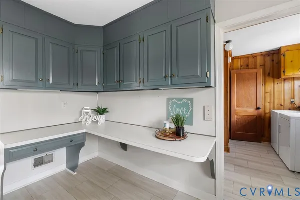 a kitchen with a refrigerator and potted plant