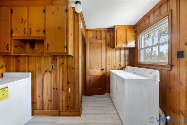a view of a bathroom with a sink a window and storage