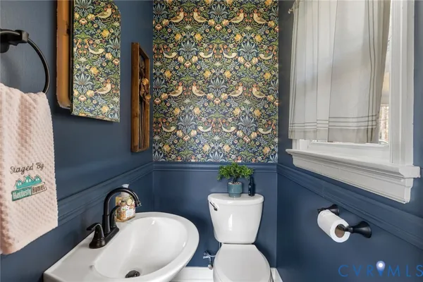 a bathroom with a toilet sink and mirror