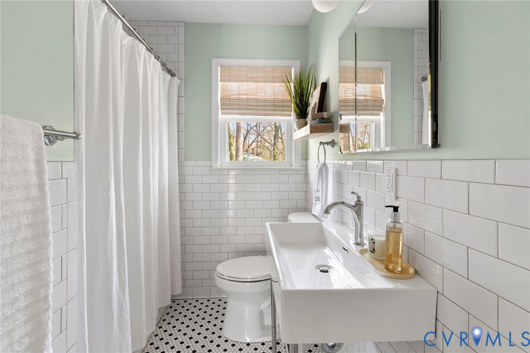 3407 Cooper Road Richmond, VA 23225 - Photo 23 of 33 a bathroom with a toilet sink and mirror