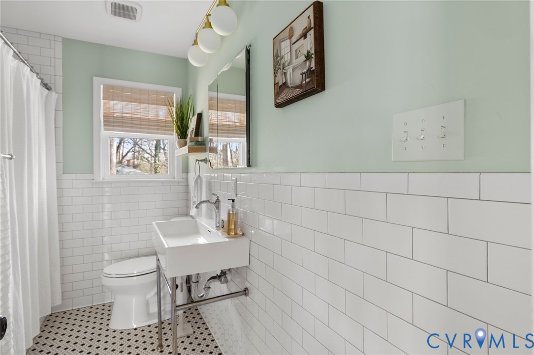 3407 Cooper Road Richmond, VA 23225 - Photo 24 of 33 a bathroom with a sink toilet and mirror