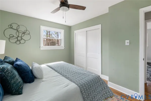 a bedroom with a large bed and a chandelier