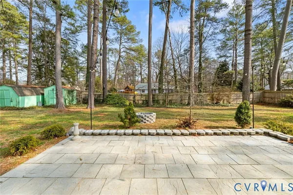 a view of a yard with large trees