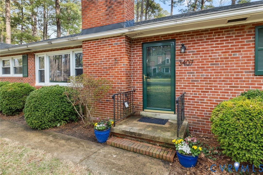 3407 Cooper Road Richmond, VA 23225 - Photo 4 of 33 a view of a door and chair and potted plants