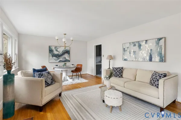 a living room with furniture and a dining table