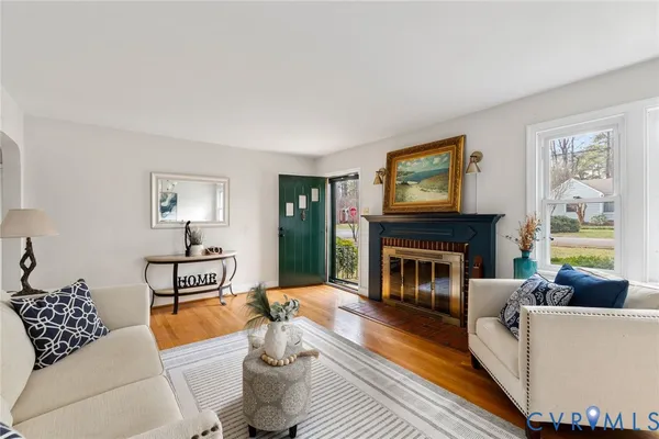 a living room with furniture and a fireplace