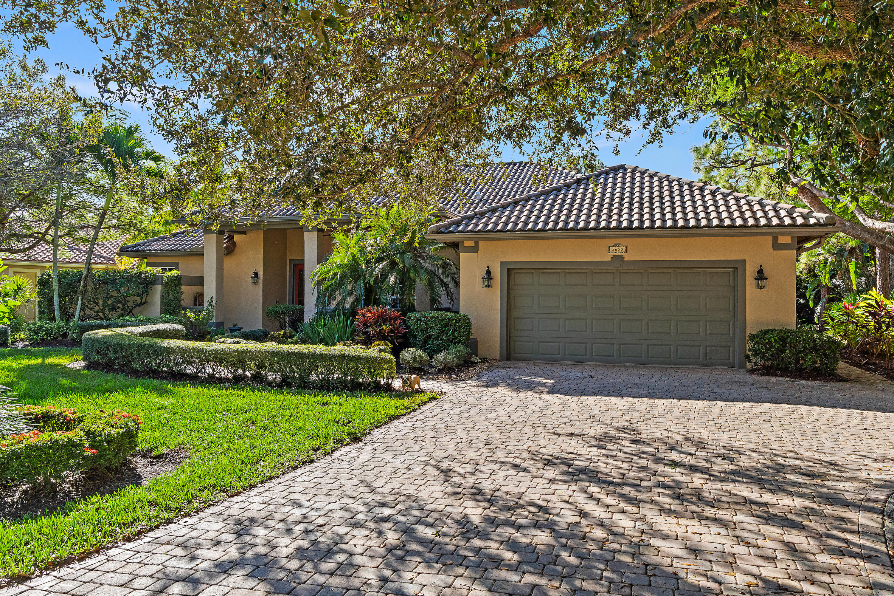 2650 Southwest Windship Way Stuart, FL 34997 - Photo 12 of 82 a front view of a house with a garden