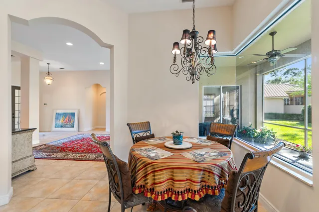 a bedroom with furniture and a large window