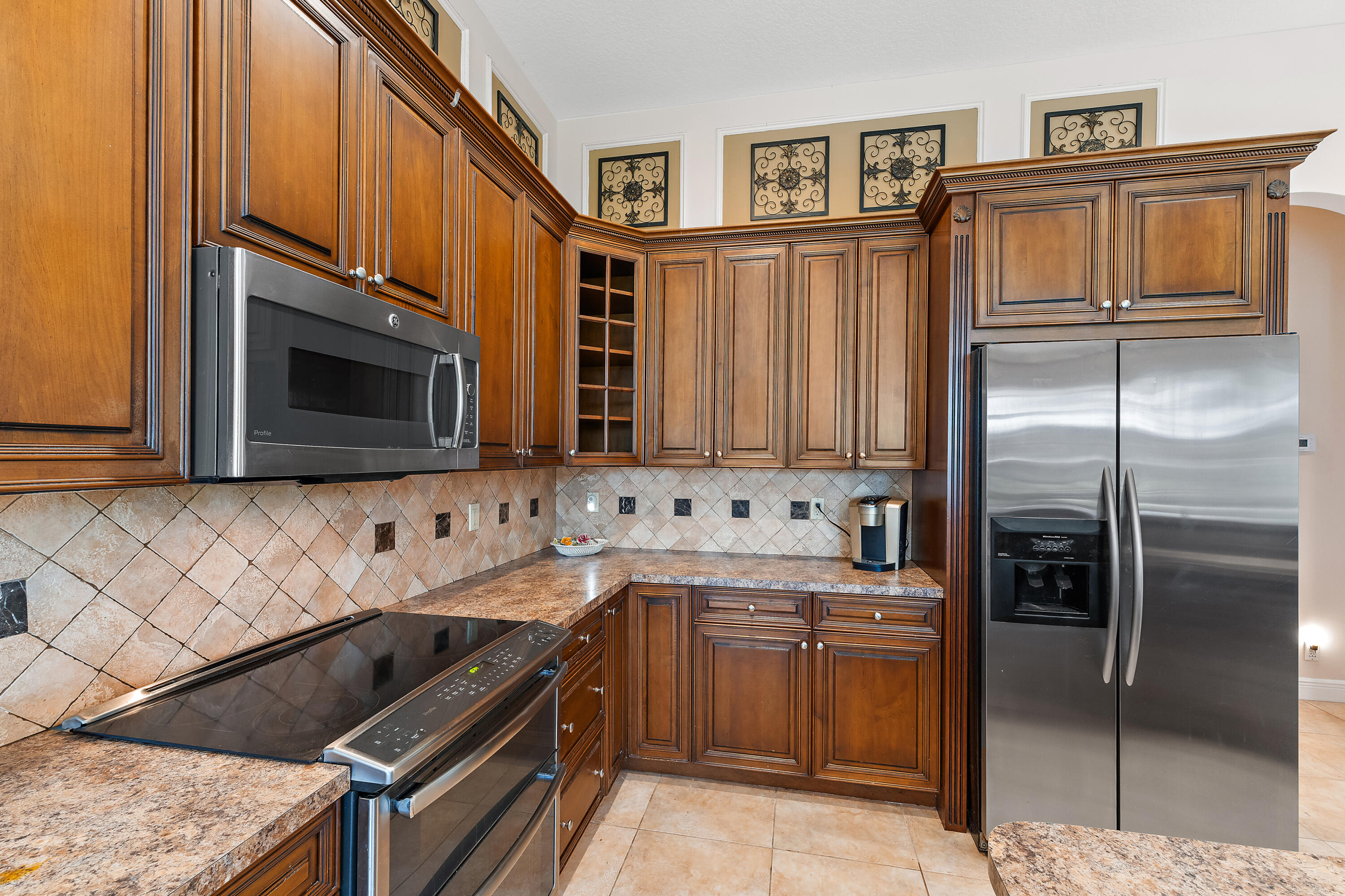 2650 Southwest Windship Way Stuart, FL 34997 - Photo 35 of 82 a kitchen with stainless steel appliances granite countertop a stove microwave and refrigerator