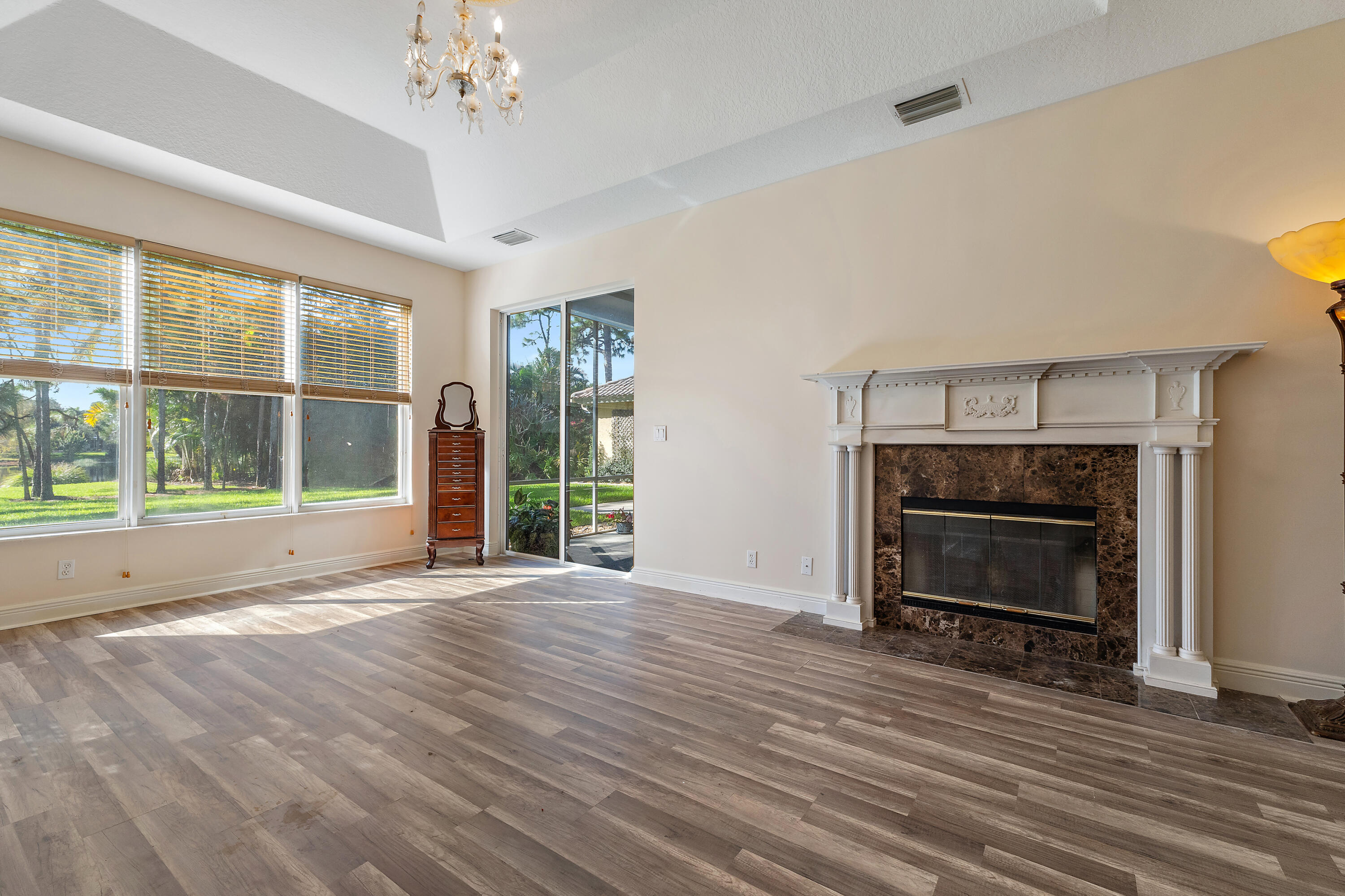 2650 Southwest Windship Way Stuart, FL 34997 - Photo 40 of 82 a view of an empty room with wooden floor fireplace and a window