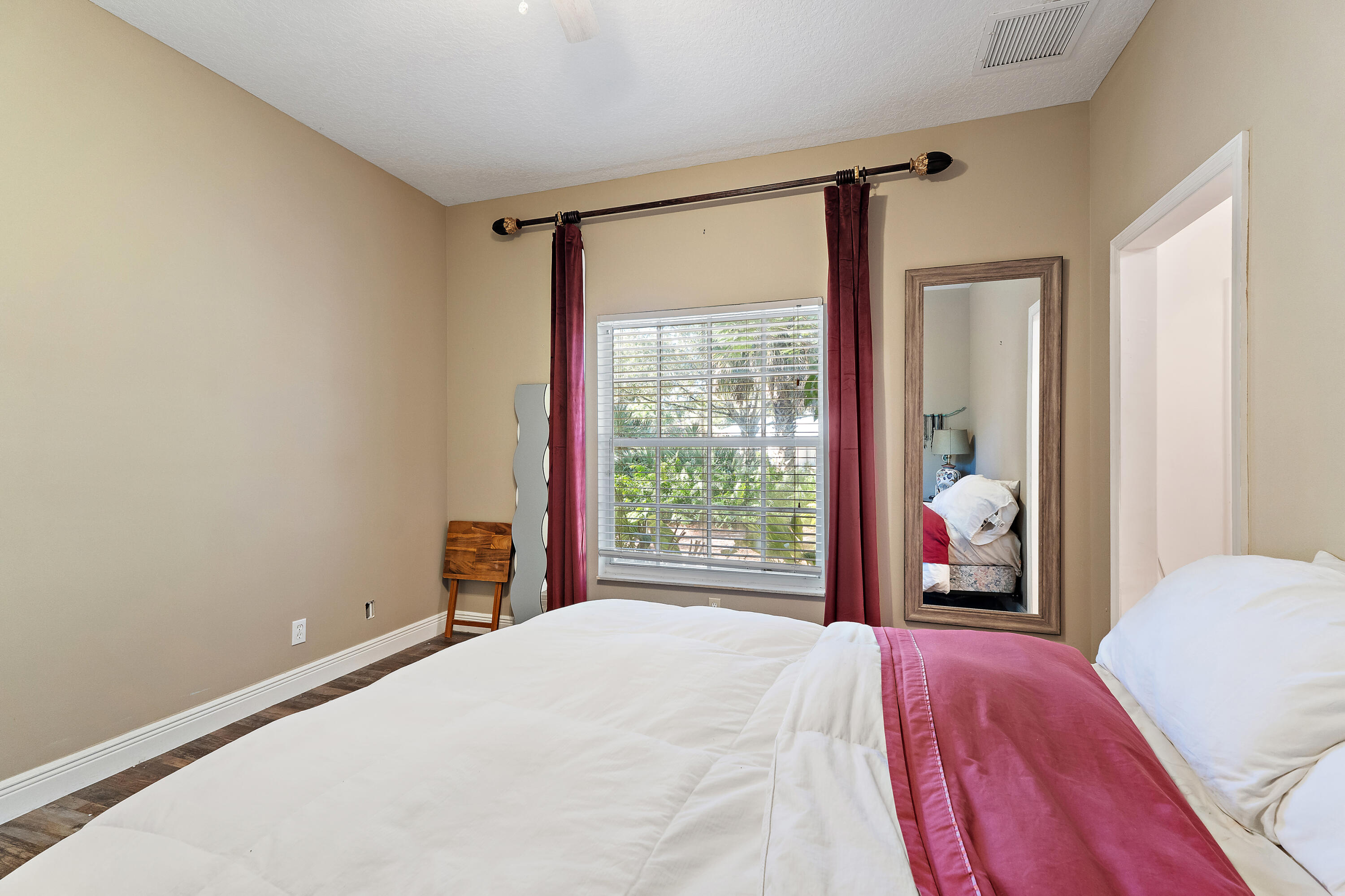 2650 Southwest Windship Way Stuart, FL 34997 - Photo 57 of 82 a bedroom with a large bed and a large window