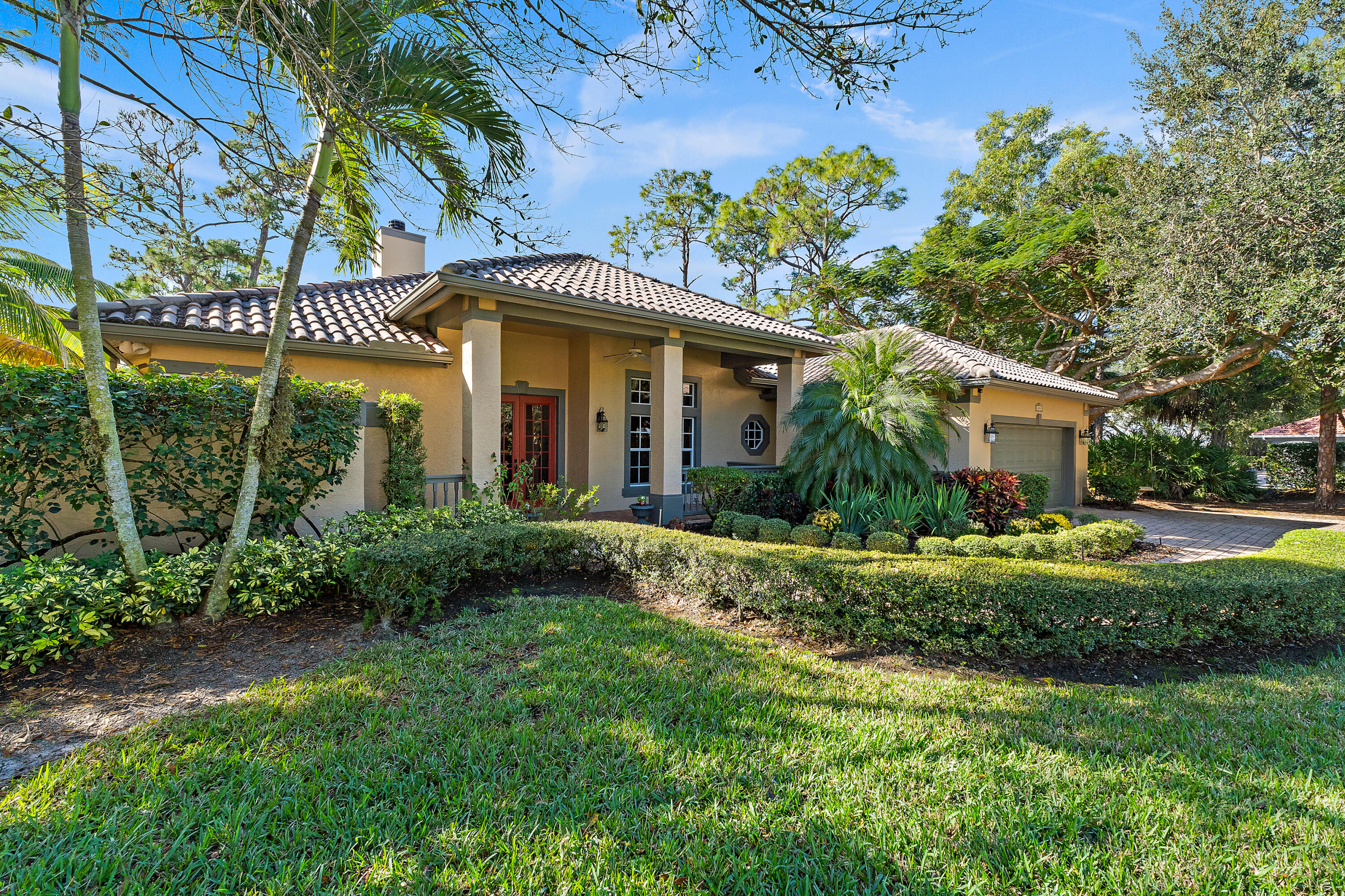 2650 Southwest Windship Way Stuart, FL 34997 - Photo 9 of 82 a front view of a house with a garden
