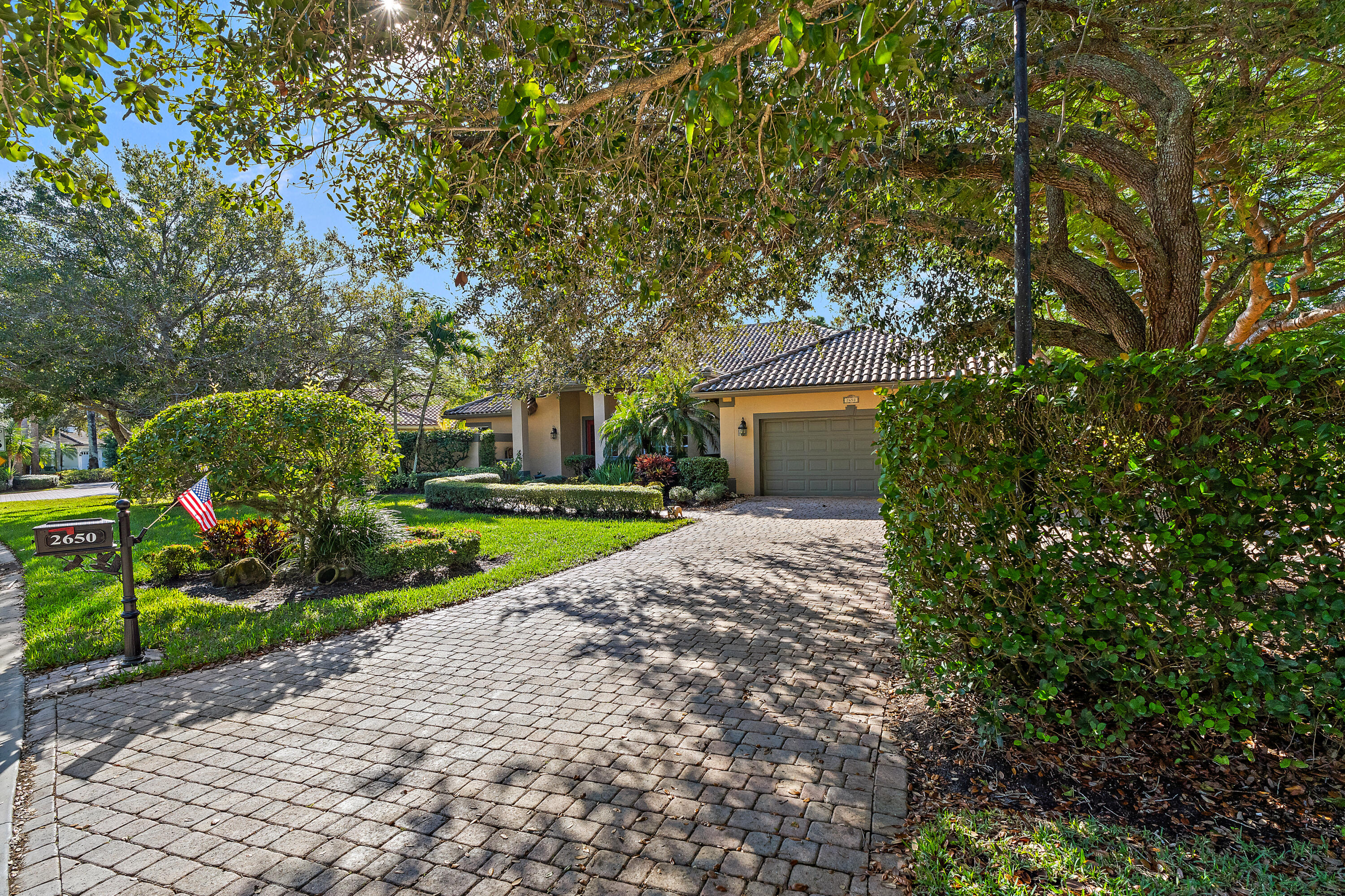 2650 Southwest Windship Way Stuart, FL 34997 - Photo 10 of 82 a view of a house with a small yard and large trees