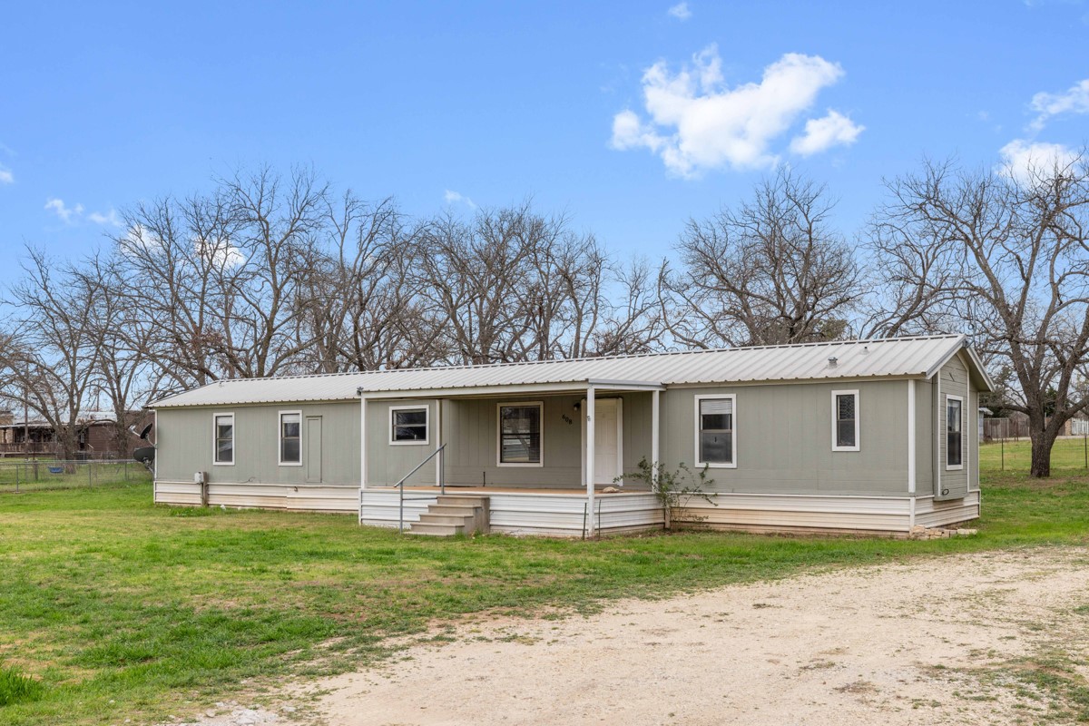 608 4th Street Blanket, TX 76432 - Photo 13 of 24 a view of a yard in front of a house with large trees