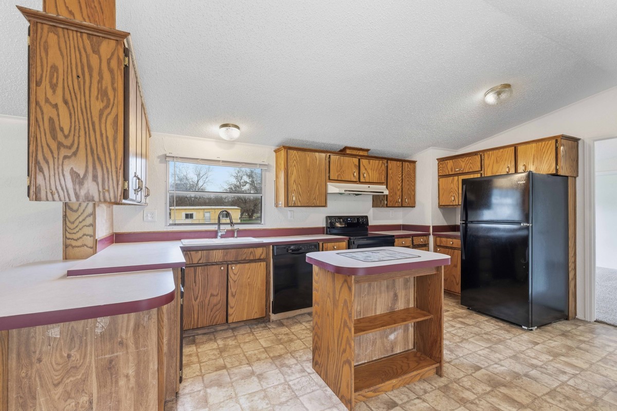 608 4th Street Blanket, TX 76432 - Photo 3 of 24 a kitchen with a sink stove and refrigerator