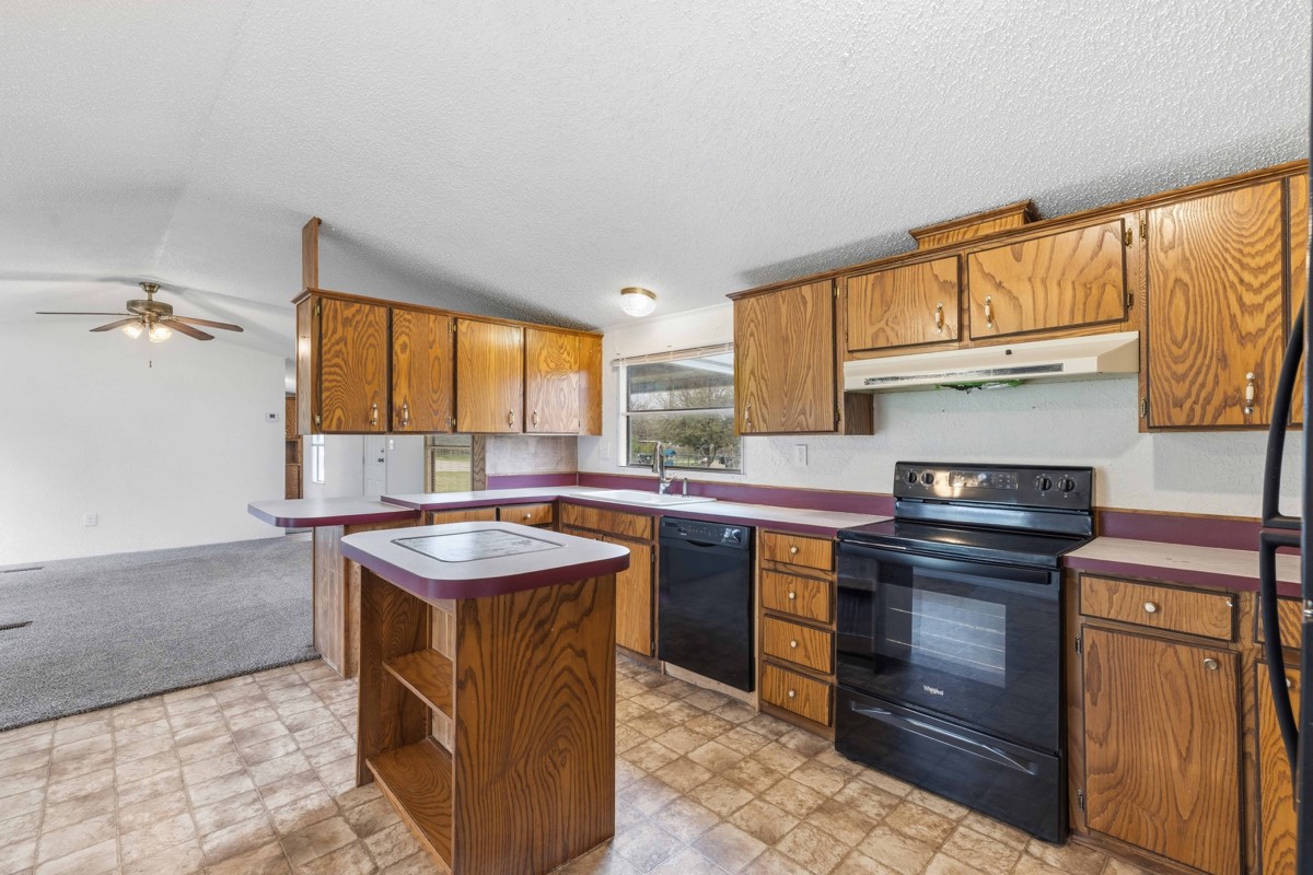 608 4th Street Blanket, TX 76432 - Photo 4 of 24 a kitchen with a stove sink and cabinets