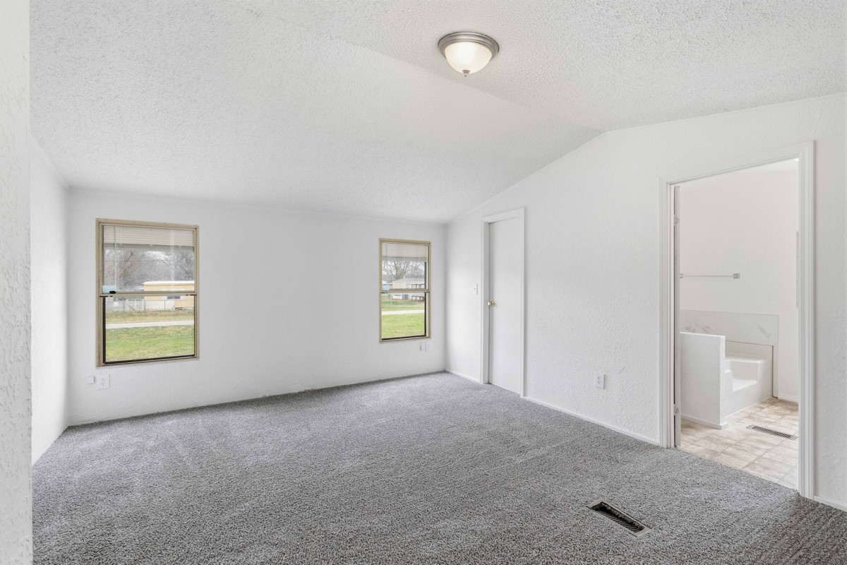 608 4th Street Blanket, TX 76432 - Photo 7 of 24 an empty room with a window and a bathroom
