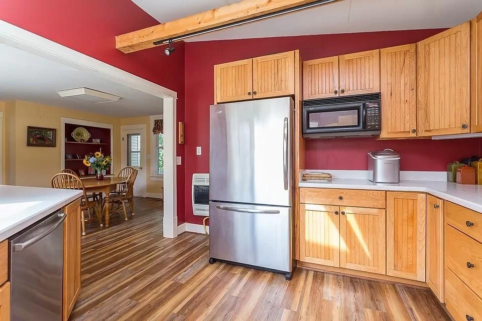 163 Pleasant View Road Staunton, VA 24401 - Photo 13 of 50 a kitchen with stainless steel appliances granite countertop a refrigerator a microwave oven on a dining table and chairs with wooden floor
