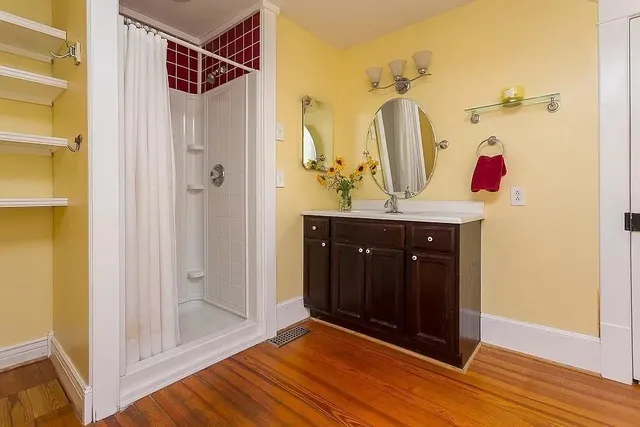 a bathroom with a shower and a sink