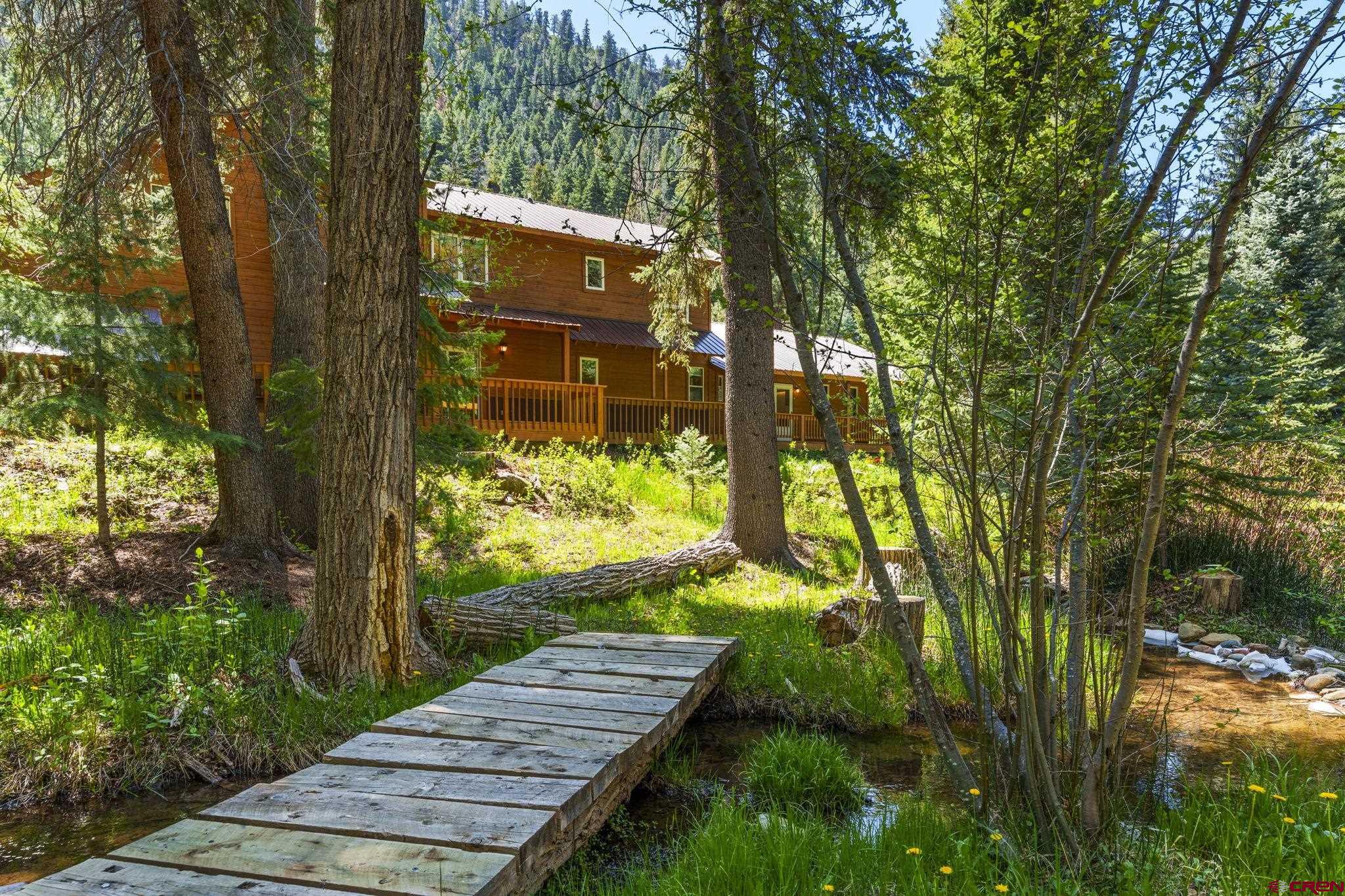 37 Verde Lane Durango, CO 81301 - Photo 2 of 45 a view of a yard with plants and large trees