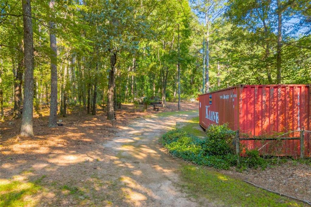 1329 Harmony Grove Church Road Auburn, GA 30011 - Photo 16 of 20 a view of backyard with tree and a wooden fence