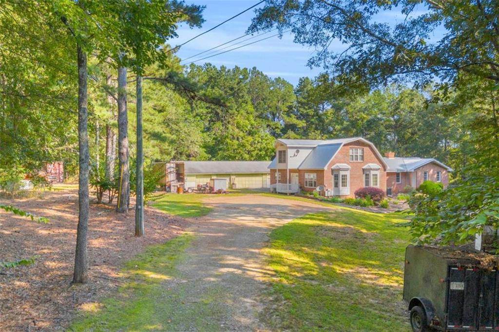 1329 Harmony Grove Church Road Auburn, GA 30011 - Photo 19 of 20 a view of a house with a yard and tree s