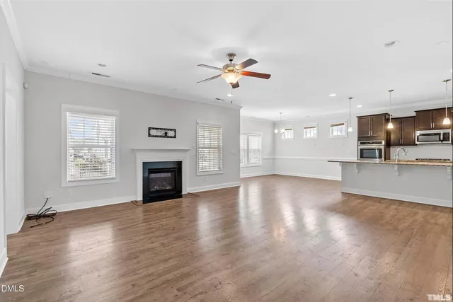 a kitchen with stainless steel appliances granite countertop a sink refrigerator and cabinets