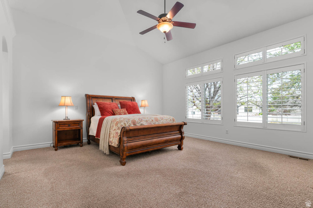 439 East 13540 South Draper, UT 84020 - Photo 14 of 46 Spacious room featuring vaulted ceilings, plush carpeting, multiple windows with plantation shutters, and a ceiling fan with integrated lighting