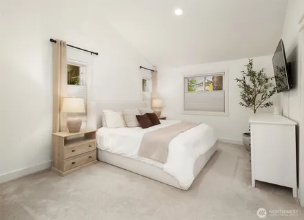 a bed room with a bed and a flat screen tv