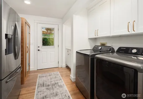 a utility room with cabinets washer and dryer