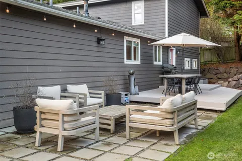 a view of a patio with a table and chairs under an umbrella