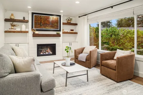 a living room with furniture fireplace and flat screen tv
